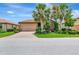 Charming single Gathering home with a well-manicured lawn, large garage, and palm trees at 6814 Willowshire Way, Bradenton, FL 34212