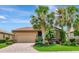 Charming home featuring a brick driveway, a tile roof, a two car garage and beautiful landscaping at 6814 Willowshire Way, Bradenton, FL 34212