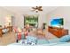 Comfortable living room with large window to screened porch, tile floors, ceiling fan and media center at 6814 Willowshire Way, Bradenton, FL 34212