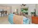 Bright living room with tile floors, ceiling fan and comfortable seating with large window to screened porch at 6814 Willowshire Way, Bradenton, FL 34212
