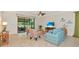 Spacious living room with tile floors, ceiling fan, comfortable seating and large window to screened porch at 6814 Willowshire Way, Bradenton, FL 34212