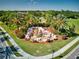 Aerial view of the community's water feature with vibrant landscaping and mature palm trees at 6814 Willowshire Way, Bradenton, FL 34212