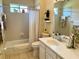 Bright bathroom with a bathtub, shower, vanity, and stylish decor at 7619 Teal Trace, Bradenton, FL 34203