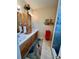 Bathroom with dual sinks, wooden vanity, and decorative accents at 7619 Teal Trace, Bradenton, FL 34203