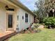 Charming home exterior with lush garden bed, walkway, and decorative front door at 7619 Teal Trace, Bradenton, FL 34203
