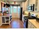 Charming kitchen featuring stainless steel appliances and bright window with natural light at 7619 Teal Trace, Bradenton, FL 34203