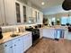 Modern kitchen featuring stainless steel appliances, white cabinetry, and wood flooring at 7619 Teal Trace, Bradenton, FL 34203