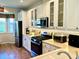 Bright kitchen featuring stainless steel appliances, including a refrigerator and gas range at 7619 Teal Trace, Bradenton, FL 34203