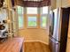 Cozy breakfast nook with stainless steel refrigerator and shuttered windows offering natural light at 7619 Teal Trace, Bradenton, FL 34203