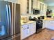Spacious kitchen with stainless steel refrigerator and range, complemented by ample cabinet space at 7619 Teal Trace, Bradenton, FL 34203