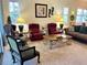 Inviting living room with comfortable seating, area rug, and natural light from multiple windows at 7619 Teal Trace, Bradenton, FL 34203