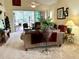 Spacious living room featuring a ceiling fan and glass doors to the screened patio at 7619 Teal Trace, Bradenton, FL 34203