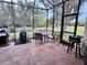Enclosed patio with a dining set and grill, perfect for outdoor dining at 7619 Teal Trace, Bradenton, FL 34203