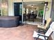 Covered patio with a hot tub and seating opens to the living room through sliding glass doors at 7619 Teal Trace, Bradenton, FL 34203