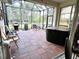 Spacious screened-in patio features brick flooring, a hot tub, seating, and outdoor cooking space at 7619 Teal Trace, Bradenton, FL 34203