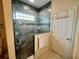 Updated tiled glass shower enclosure with pebble floor and built in shelf at 7619 Teal Trace, Bradenton, FL 34203