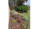 Landscaped yard features tropical plants and mulch at 7619 Teal Trace, Bradenton, FL 34203