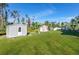 Lush backyard featuring two storage sheds with a privacy fence in the background at 8059 Strasse Blvd, Punta Gorda, FL 33982