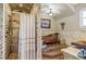 Elegant bathroom featuring tiled shower and copper soaking tub with stylish fixtures at 8059 Strasse Blvd, Punta Gorda, FL 33982
