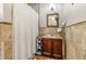 Bathroom with a shower, vanity, and travertine tile at 8059 Strasse Blvd, Punta Gorda, FL 33982