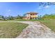 Two-story home with tile roof, balcony, and ample outdoor space at 8059 Strasse Blvd, Punta Gorda, FL 33982