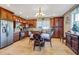 Kitchen featuring wood cabinets, stainless steel appliances, tile floor, and dining area at 8059 Strasse Blvd, Punta Gorda, FL 33982