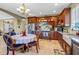 Kitchen featuring wood cabinets, stainless steel appliances, tile floor, and dining area at 8059 Strasse Blvd, Punta Gorda, FL 33982