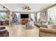 Bright living room featuring a ceiling fan, tile floors, and large windows at 8059 Strasse Blvd, Punta Gorda, FL 33982
