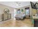 Bedroom with neutral tones, ceiling fan, and tiled floors, featuring a dresser and private entry at 8059 Strasse Blvd, Punta Gorda, FL 33982