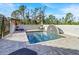 Outdoor pool area featuring stone pavers and a unique water feature and lounge chairs for relaxing at 8059 Strasse Blvd, Punta Gorda, FL 33982