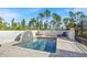 Backyard pool with a unique water feature, landscaping and a privacy wall with lounge chairs for relaxing at 8059 Strasse Blvd, Punta Gorda, FL 33982