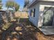 Fenced backyard with a small patio area and room for outdoor activities at 2040 Pine Ridge Dr, Clearwater, FL 33763