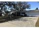 Charming single-story home featuring a large driveway, mature trees, and an attached two-car garage at 2040 Pine Ridge Dr, Clearwater, FL 33763