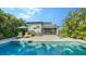 Beautiful backyard with a sparkling pool, lounge chairs, and an outdoor patio, perfect for relaxation at 2434 Wood St, Sarasota, FL 34237