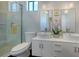 Modern bathroom featuring double sink vanity, standing shower, and decorative lighting at 2434 Wood St, Sarasota, FL 34237