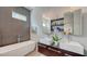 Sleek bathroom with double sinks, modern fixtures, a soaking tub, and an adjacent walk-in shower at 2434 Wood St, Sarasota, FL 34237