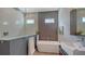 Modern bathroom featuring a soaking tub, walk-in shower, and double sinks with modern fixtures at 2434 Wood St, Sarasota, FL 34237