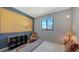 Comfortable bedroom featuring a decorative wall, window view, and stylish furnishings at 2434 Wood St, Sarasota, FL 34237