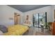 Modern bedroom with concrete floors, sliding door access to lanai, and neutral color palette at 2434 Wood St, Sarasota, FL 34237
