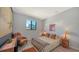 Bright bedroom with a window view, wooden floor, two bedside lamps, and decorative bed at 2434 Wood St, Sarasota, FL 34237