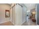 Hallway features sliding barn doors, concrete floors, and an open concept design, with a decorative mirror at 2434 Wood St, Sarasota, FL 34237