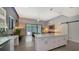 Bright kitchen with large island, modern cabinets, and sliding glass doors to the outdoor living area at 2434 Wood St, Sarasota, FL 34237