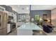 Bright kitchen features stainless steel appliances, a large island, and seamless transition to the living area at 2434 Wood St, Sarasota, FL 34237