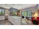 Bright kitchen offers an island with barstool seating and an open layout to the living area and pool at 2434 Wood St, Sarasota, FL 34237