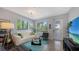 Bright living room with modern decor, sleek concrete floors, large windows, stylish furniture, and recessed lighting at 2434 Wood St, Sarasota, FL 34237