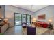 Bright living room featuring a ceiling fan, comfortable seating, and sliding doors to the outdoor pool area at 2434 Wood St, Sarasota, FL 34237