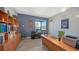 Home office featuring a large desk, wood floors, and ample shelving for storage and decor at 2434 Wood St, Sarasota, FL 34237