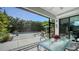 Screened-in patio featuring a modern dining table, seating, and a view of the inviting pool area at 2434 Wood St, Sarasota, FL 34237