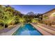 Backyard pool at twilight with tropical landscaping and outdoor seating at 2434 Wood St, Sarasota, FL 34237