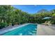 Secluded backyard pool area surrounded by lush greenery, providing a private and tranquil retreat at 2434 Wood St, Sarasota, FL 34237